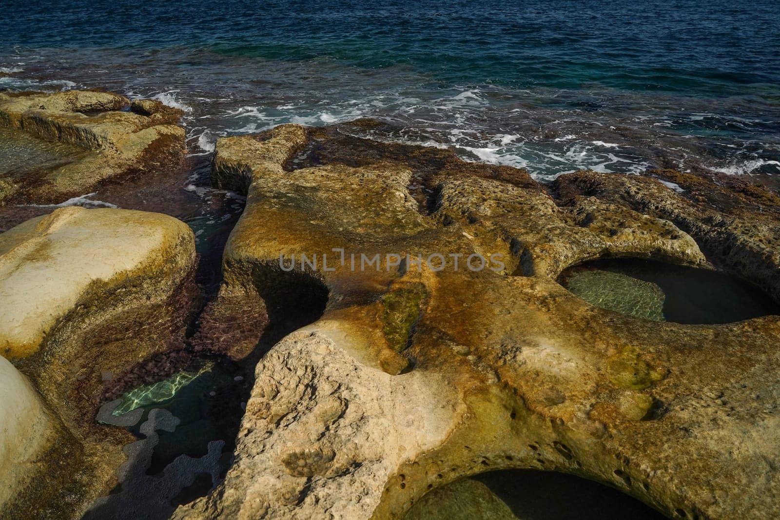 saint peter pools Malta rock formation hole on rocks by AndreaIzzotti