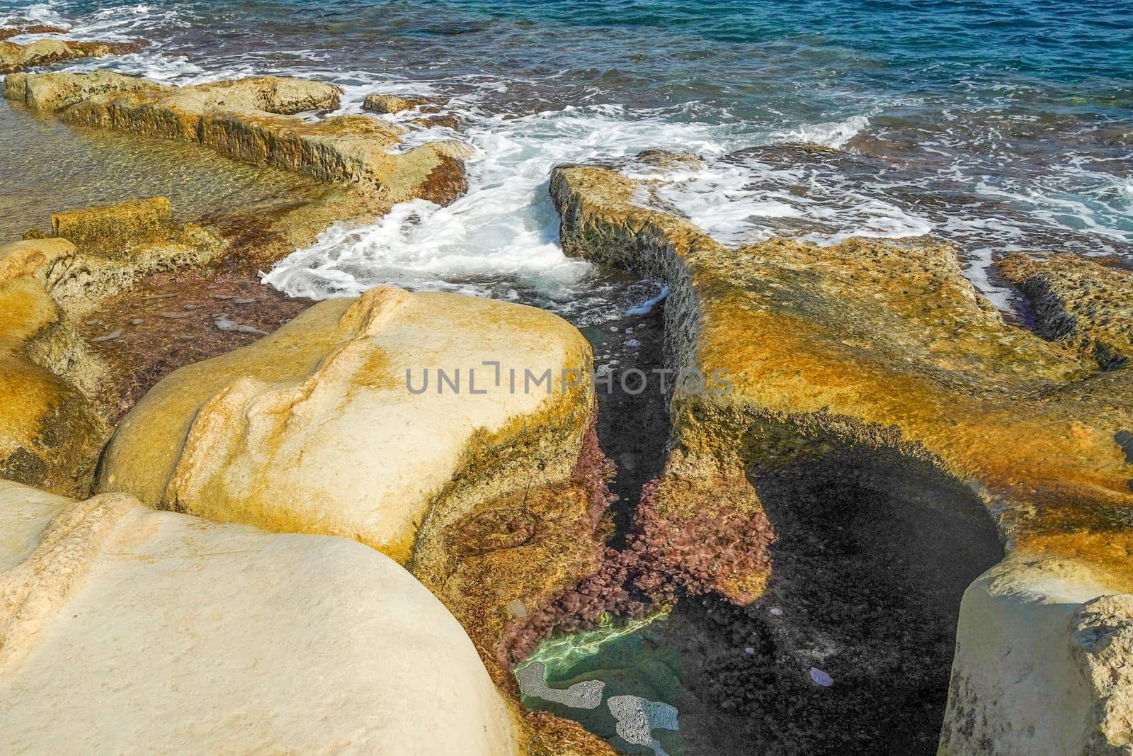 saint peter pools Malta rock formation hole on rocks by AndreaIzzotti