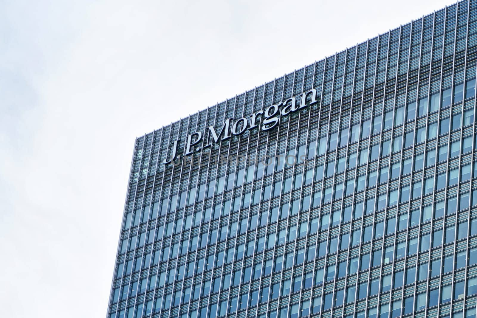 London, United Kingdom - February 03, 2019: Sun shines on J P Morgan signage at top of their UK branch at Canary Wharf. JPMorgan Chase is US multinational investment bank founded (originally) 1799 by Ivanko