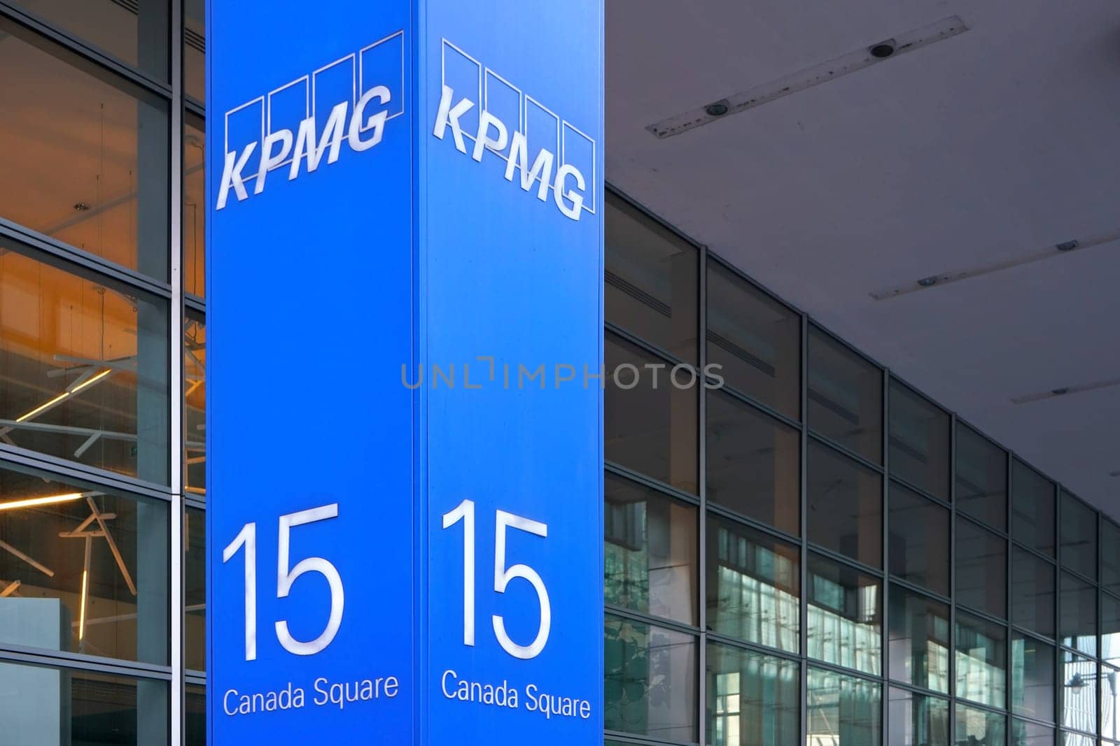 London, United Kingdom - February 03, 2019: Blue KPMG signage at entrance to their offices on 15 Canada Square in Canary Wharf - headquarters of company in the UK. It's one of big 4 accounting firms by Ivanko