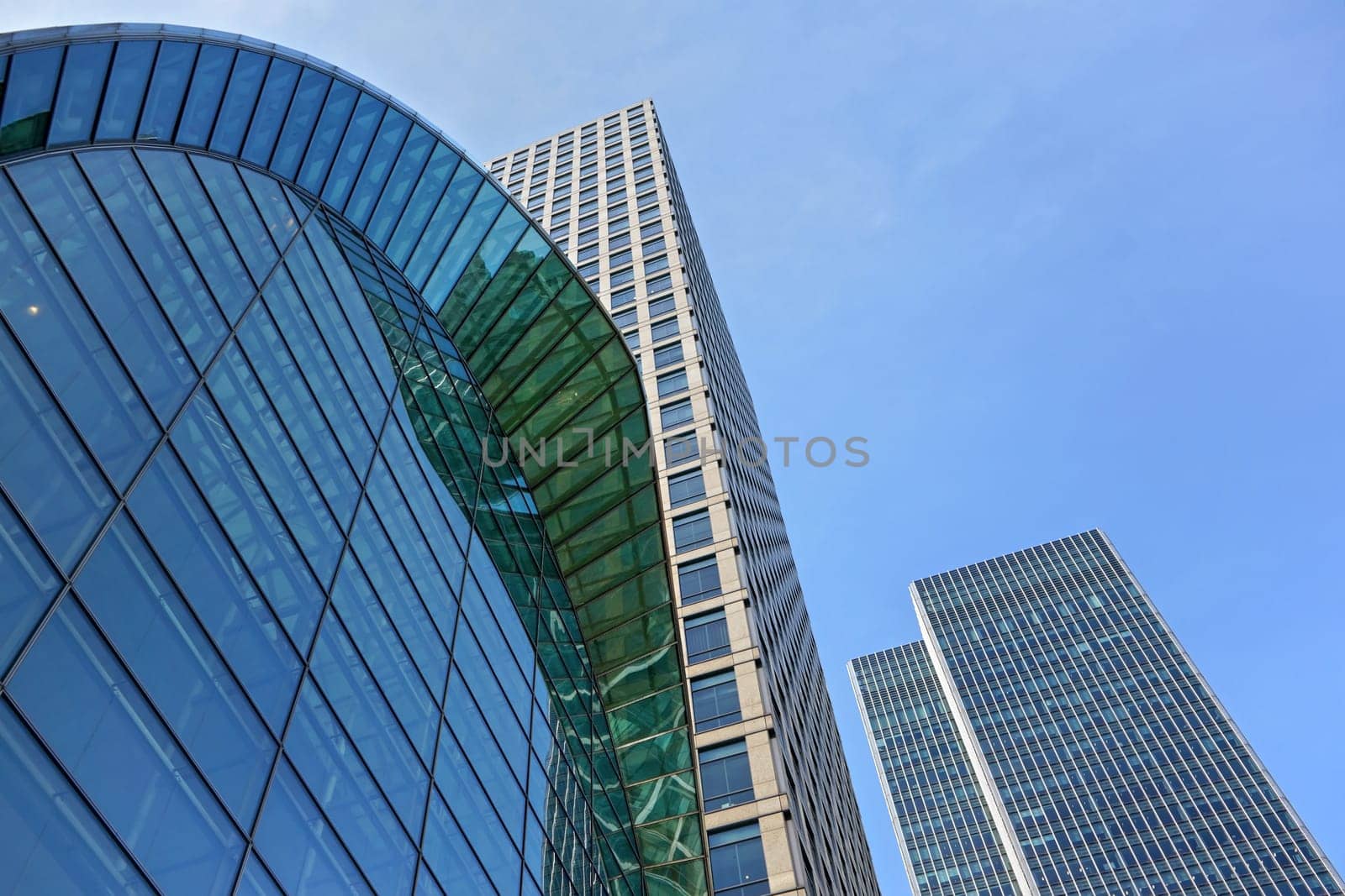 London, United Kingdom - February 03, 2019: Looking up Canada Water tube station entrance and 40 and 25 Bank Street buildings designed by Cesar Pelli & Associates on sunny day. by Ivanko
