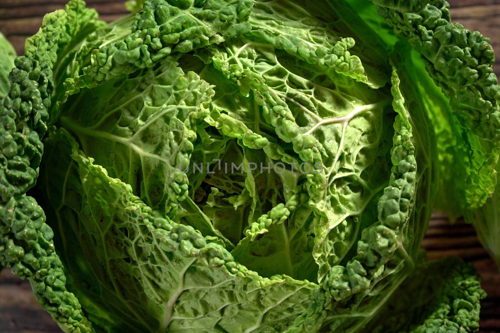 Green savoy cabbage head - Closeup from above by Ivanko