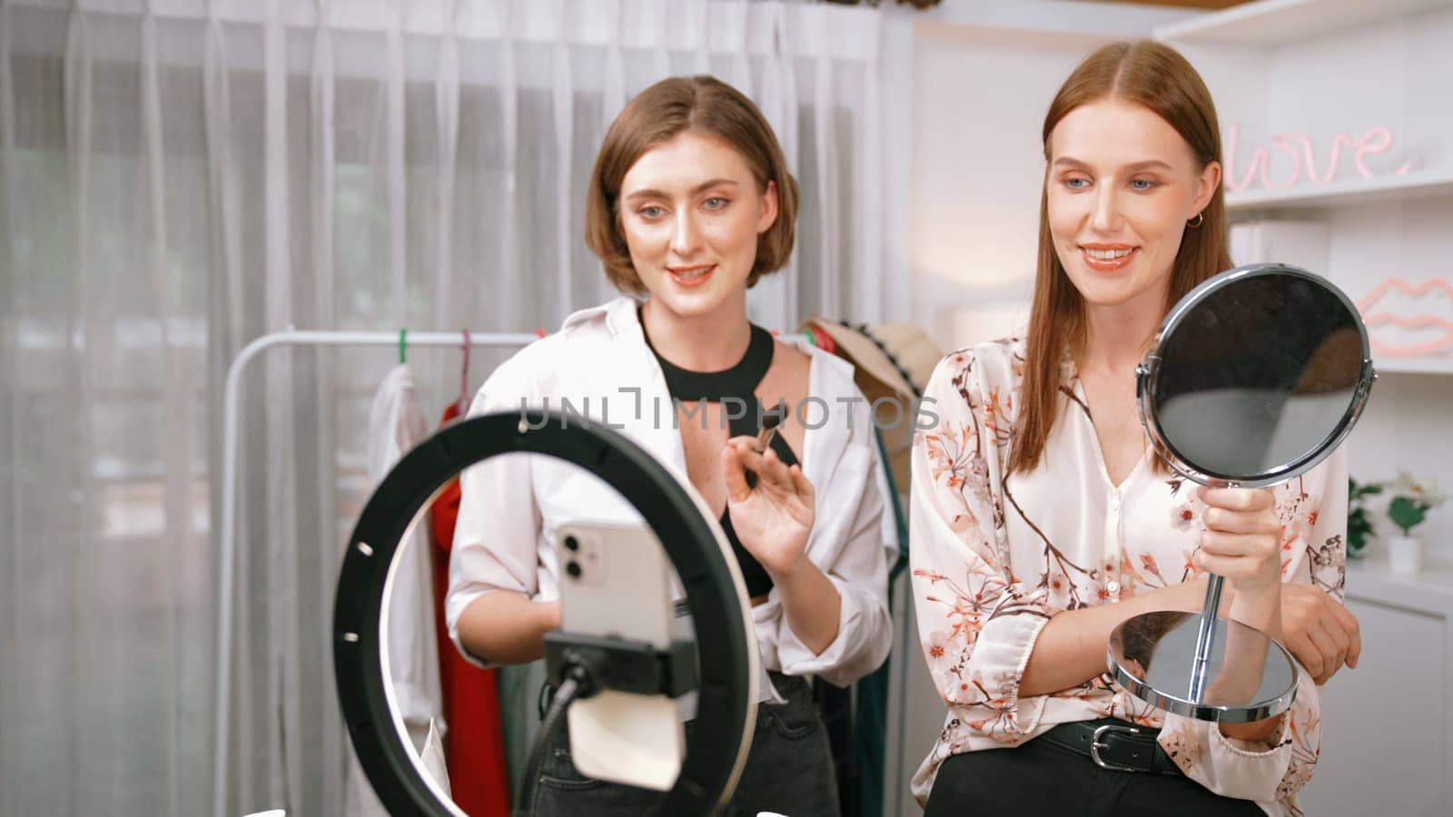 Two influencer partner shoot live streaming vlog video review makeup prim social media or blog. Happy young girl with cosmetics studio lighting for marketing recording session broadcasting online.