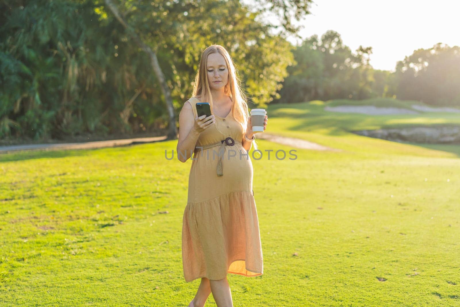 pregnant woman enjoys a cup of coffee outdoors, blending the simple pleasures of nature with the comforting warmth of a beverage during her pregnancy.