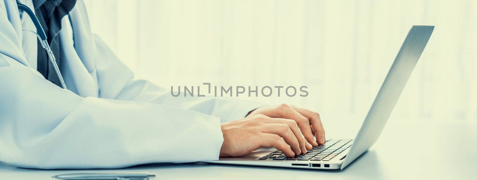 Doctor at hospital sit at his desk working on patient's medical result. Rigid by biancoblue