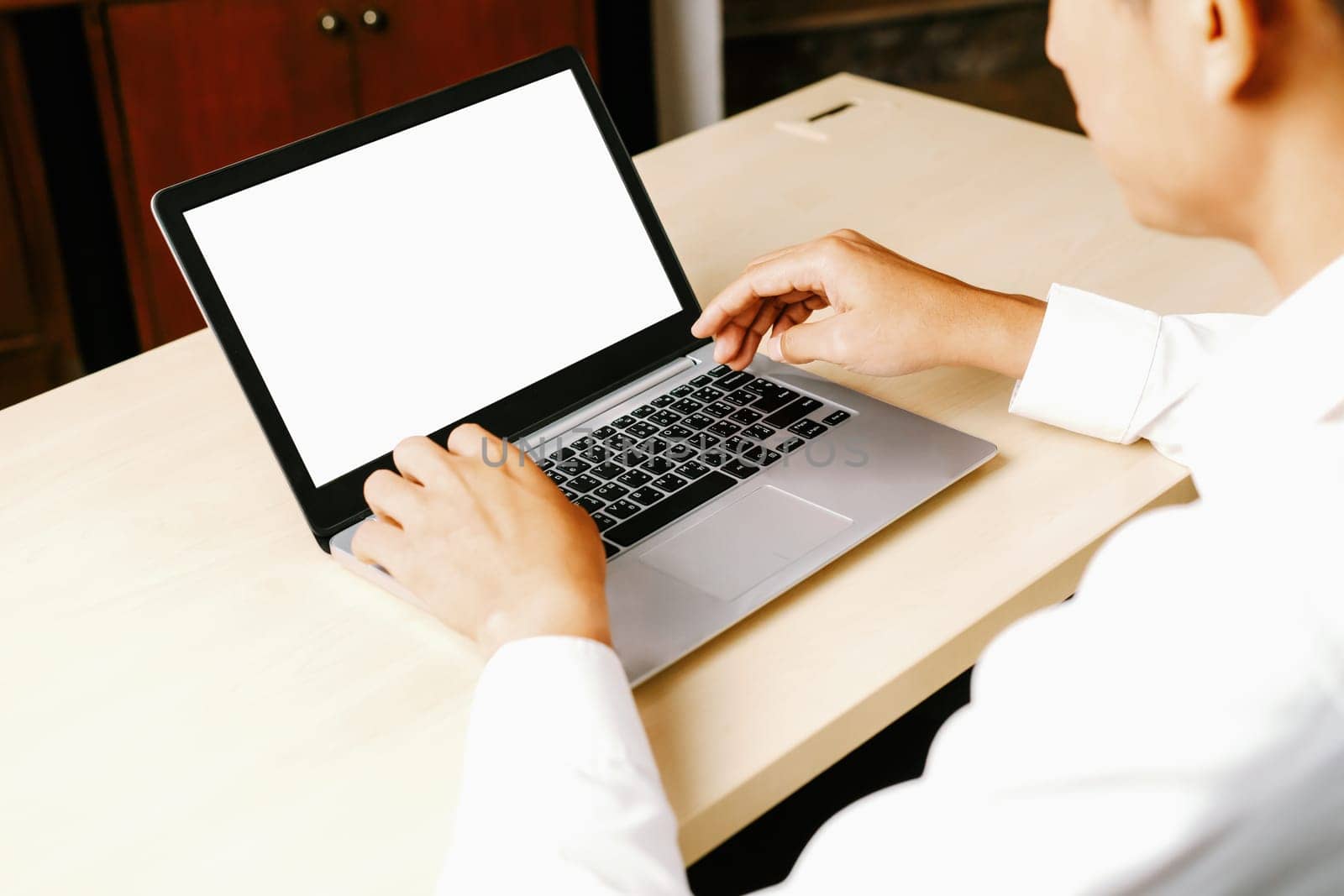 Business person or office worker using laptop computer while sitting at desk. uds