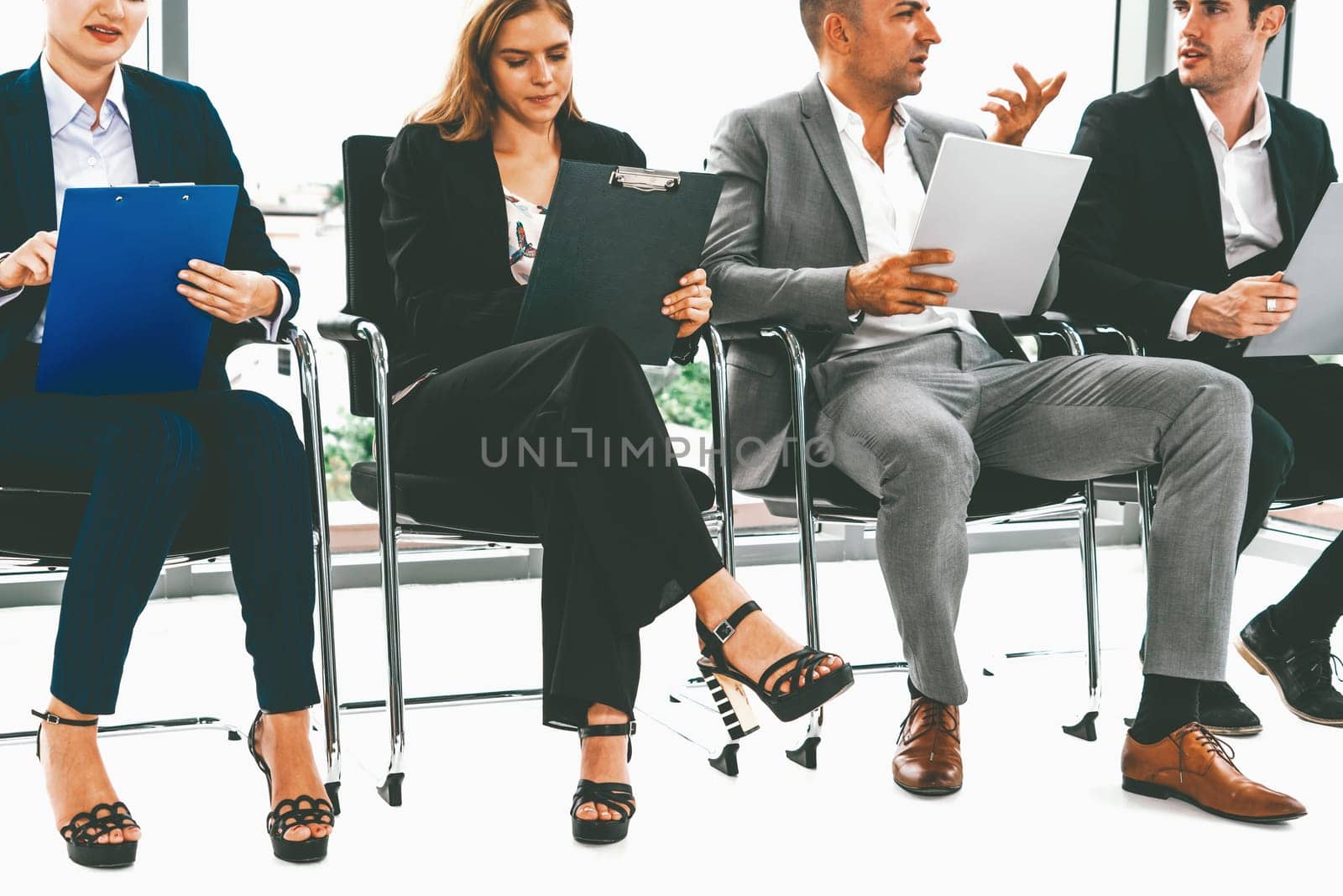 Businesswomen and businessmen wait for interview. uds by biancoblue