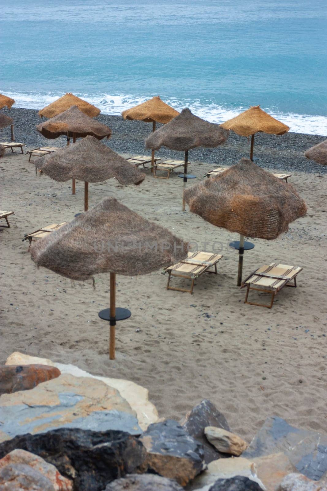 Tropical umbrella on Palinuro beach in Campania, Italy to indicate a tourism concept. High quality photo
