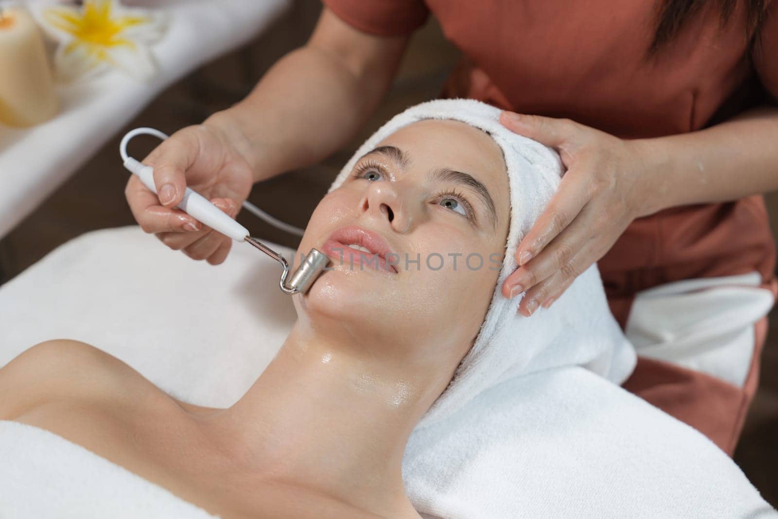 Beautiful caucasian woman having facial massage at spa. Close up. Tranquility by biancoblue