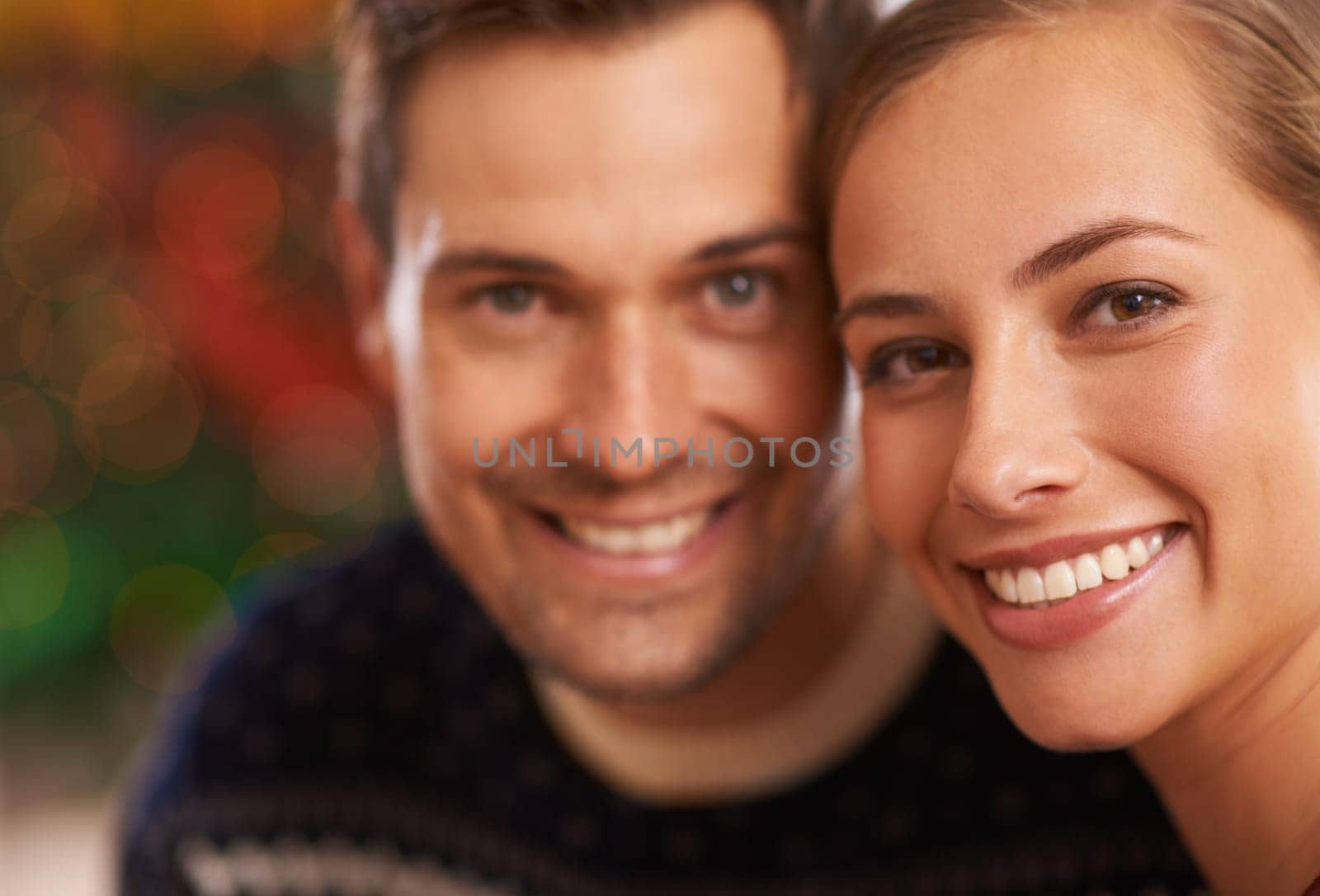 Portrait, Christmas and couple with love, festive season and party with romance and home with Xmas. Face, apartment and man with woman or celebration with holiday and smile with marriage and cheerful by YuriArcurs