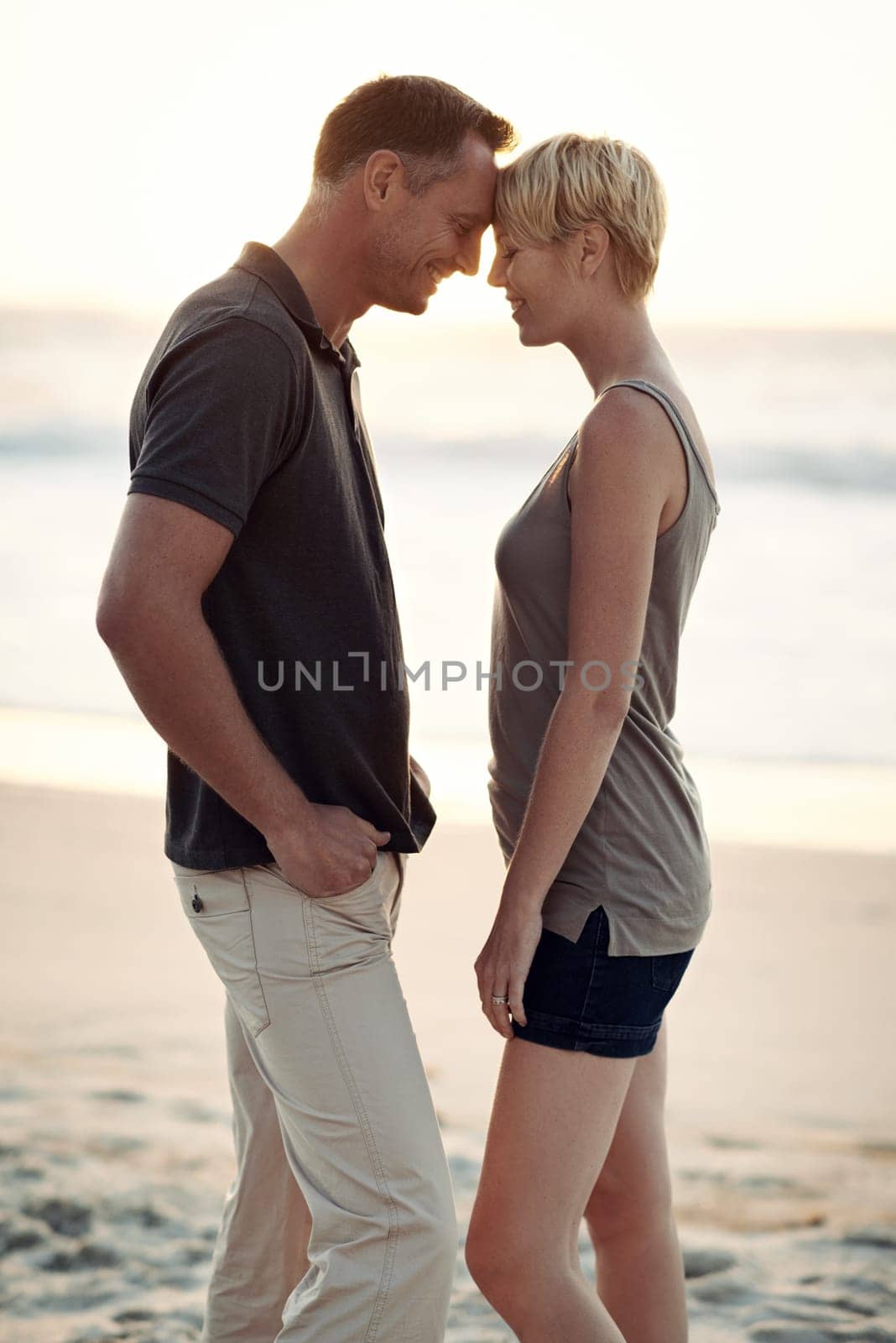 Couple, love and smile on beach with bonding for honeymoon date and weekend holiday in Seychelles. Relax, man and woman with relationship, happy and care on sea sand for vacation, travel or adventure.