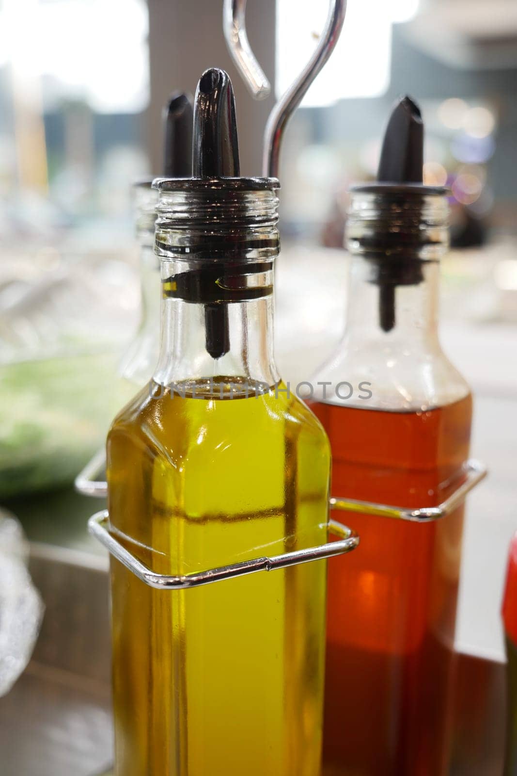 bottle of olive oil , lemon and soya sauce on table ,