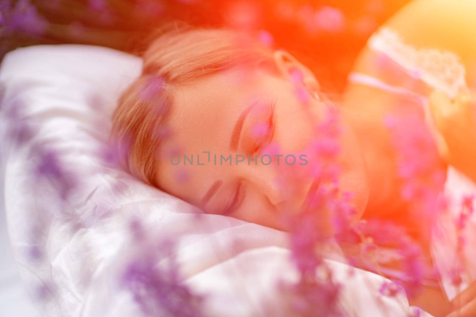 Woman lavender field. A middle-aged woman lies in a lavender field and enjoys aromatherapy. Aromatherapy concept, lavender oil, photo session in lavender by Matiunina