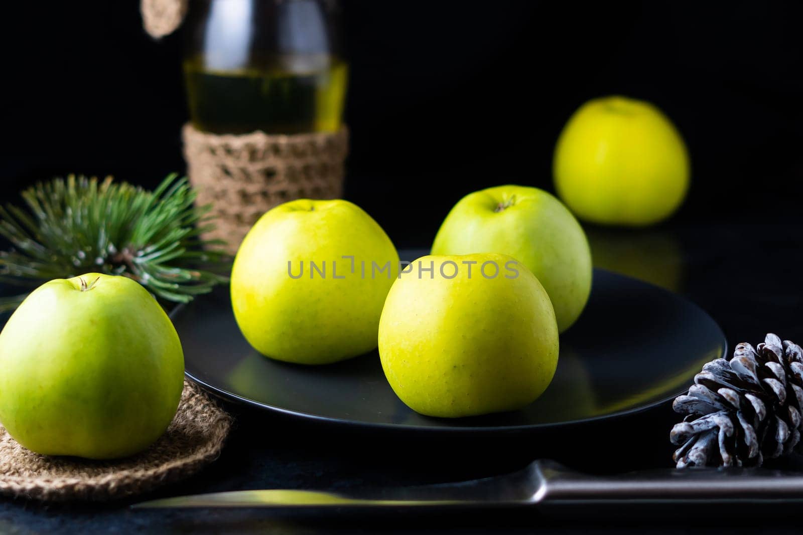 A ripe green apple fruits on dark stone table. Top view with copy space. Flat lay by Zelenin