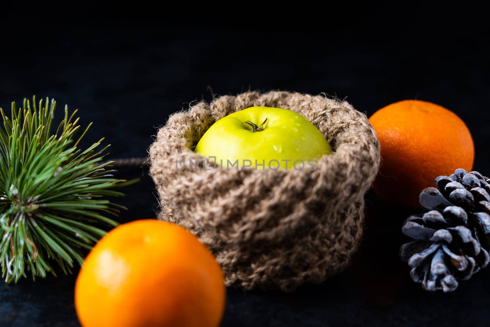 Tangerines and apples in baskets and peeled tangerine slices on the table. by Zelenin