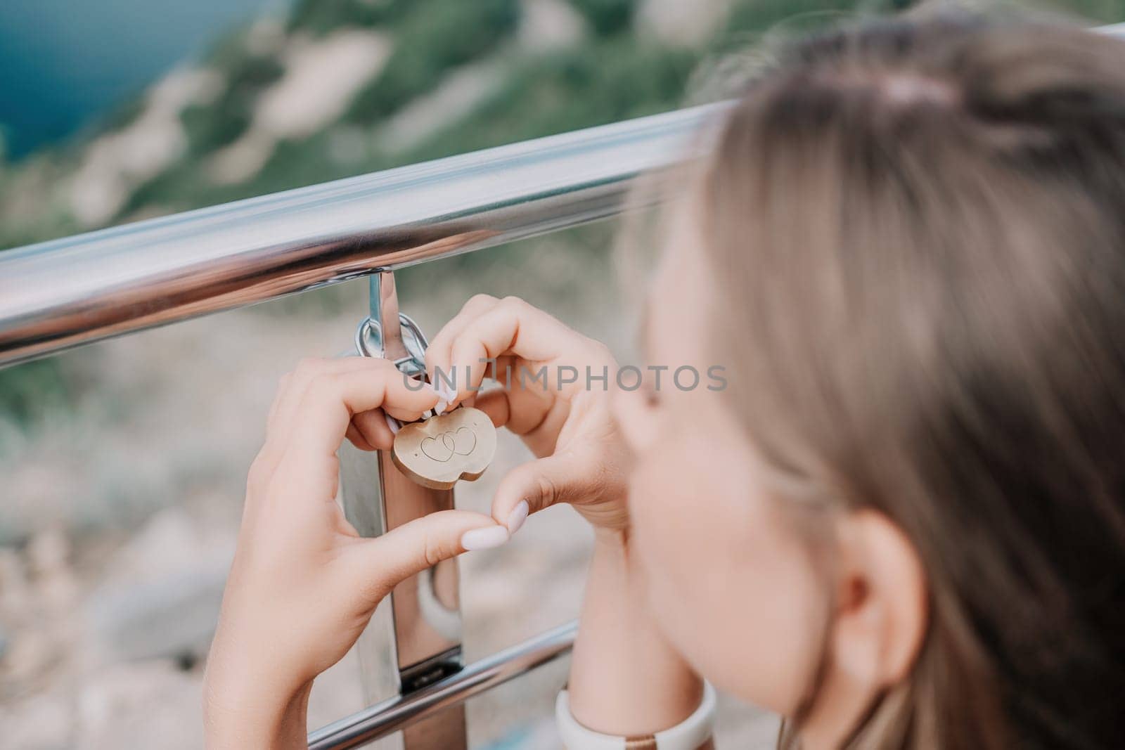 Hands, lock, heart, love, valentines day. Close-up of a woman's hands holding heart shaped padlock with a heart. The concept of Valentine's day, wedding, symbol of love and fidelity. by panophotograph