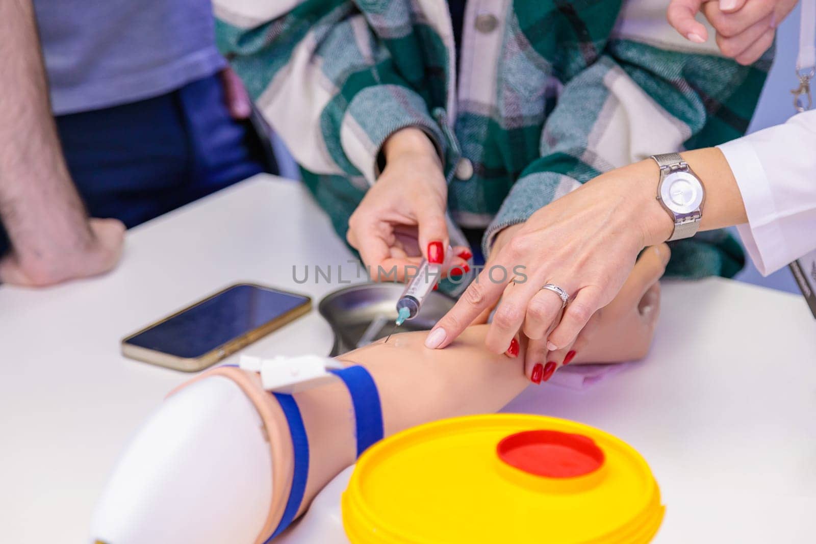 Training of blood sampling from a vein, on a model of a human hand. High quality photo