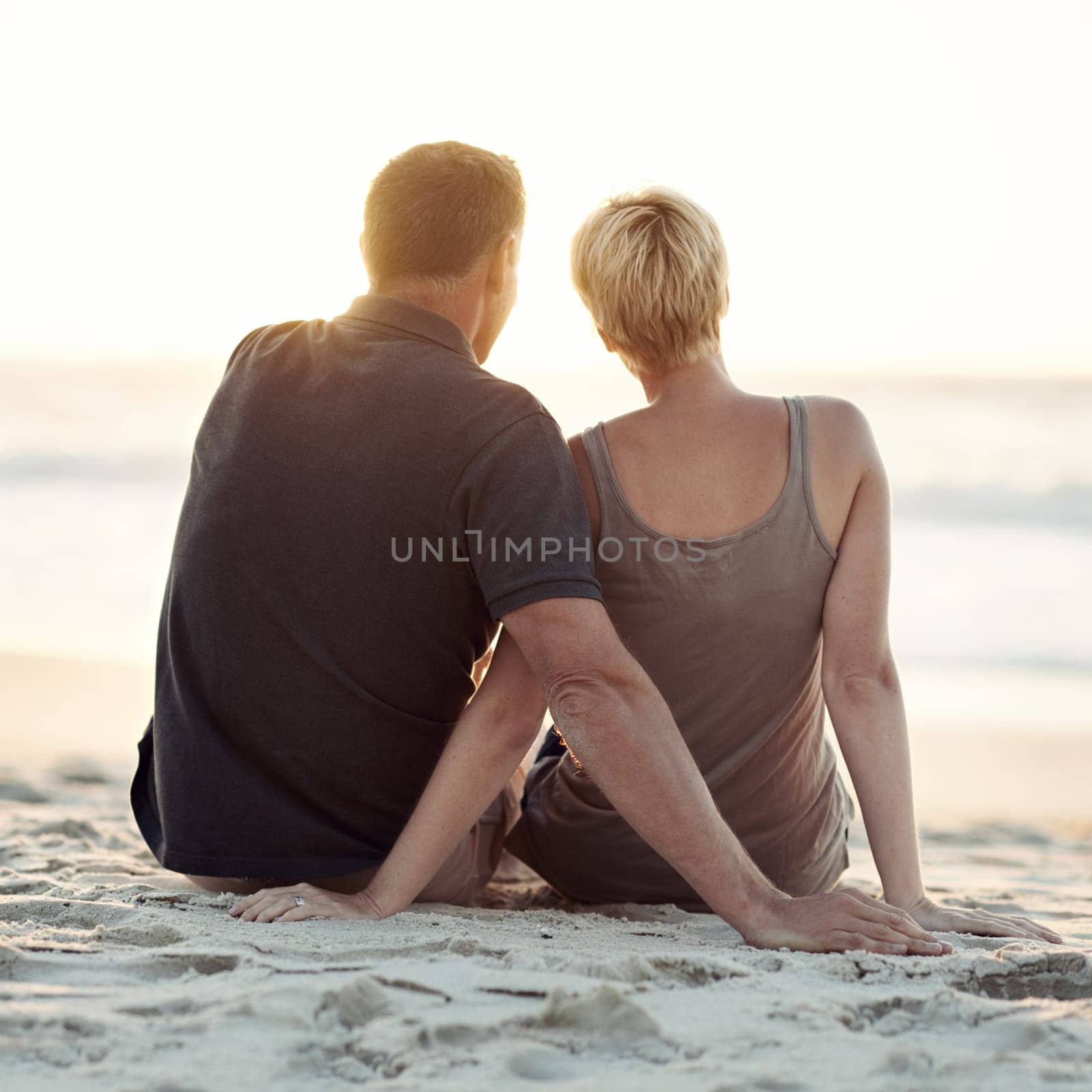 Couple, beach and sunset relax or travel vacation on tropical island for marriage commitment, holiday or paradise. Man, woman and rear view on sea sand in California for date together, rest or summer.