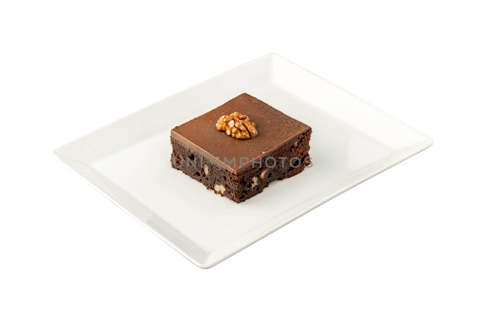 Walnut and dark chocolate brownie on a white porcelain plate on white background by Sonat