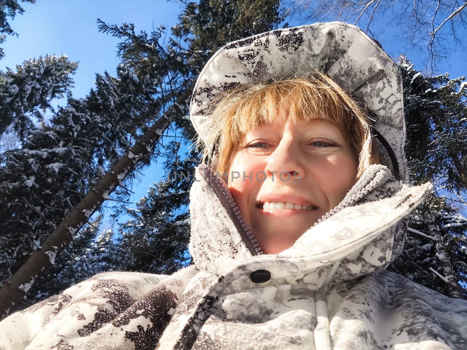 Smiling Woman on a Sunny Winter Day Outdoors on nature by keleny