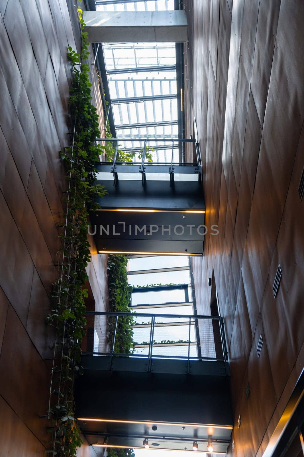 Indoor trees Modern interior design in European Solidarity Centre Gdansk Poland. Biophilia design connecting with nature green areas. Modern abstract museum in Europe. Travel destination tourist attraction