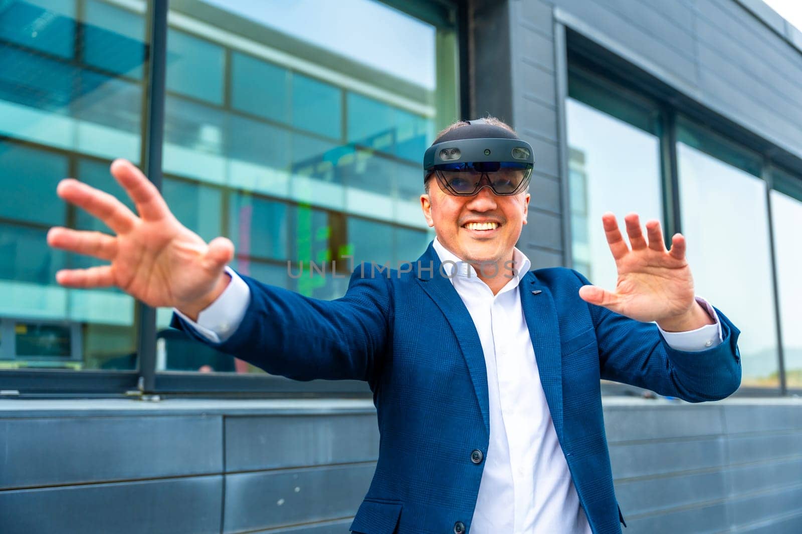 Businessman gesturing wearing augmented reality innovative goggles by Huizi