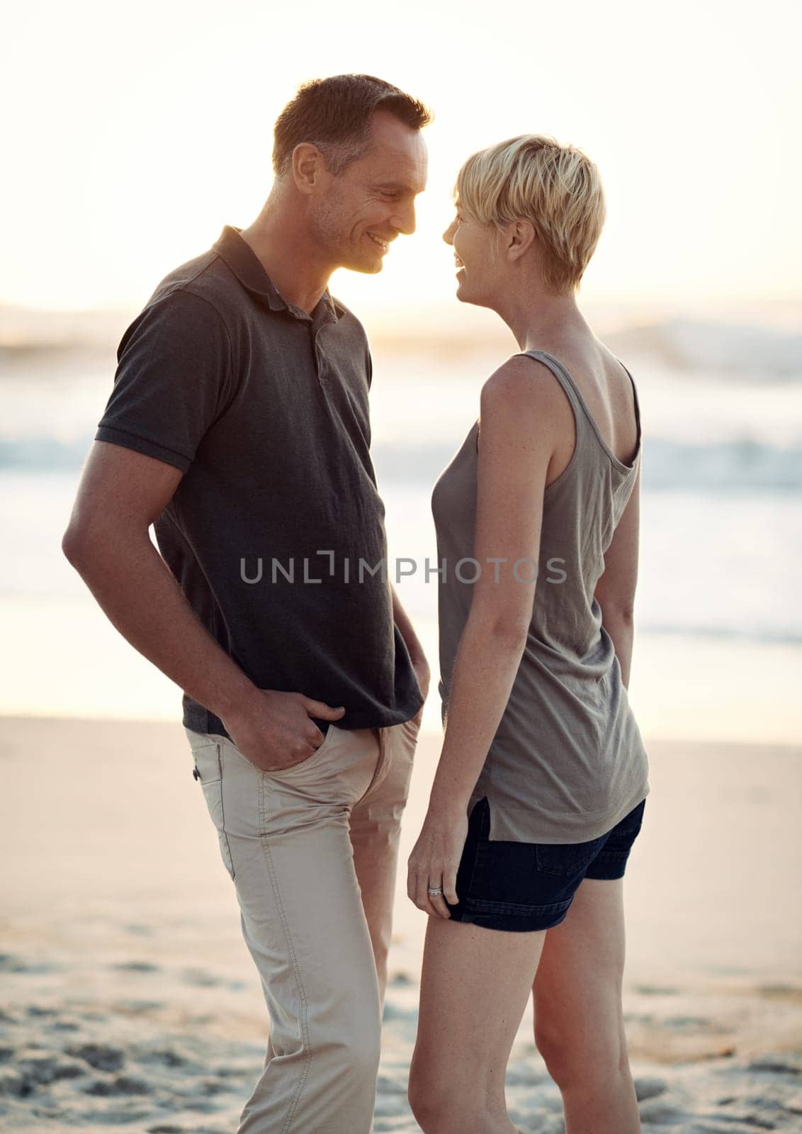 Couple, love and happy on beach with bonding for honeymoon date and weekend holiday in Seychelles. Face, man and woman with relationship, smile and care on sea sand for vacation, travel and adventure by YuriArcurs