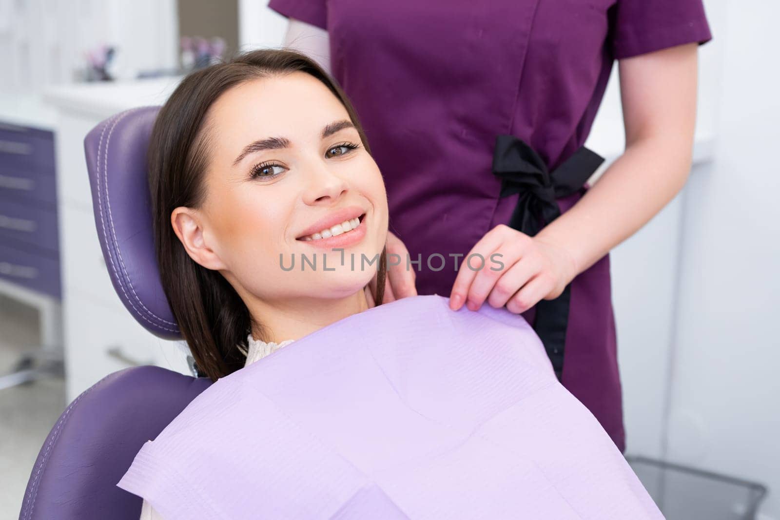 Portrait of young woman before checking up teeth at dentist office.