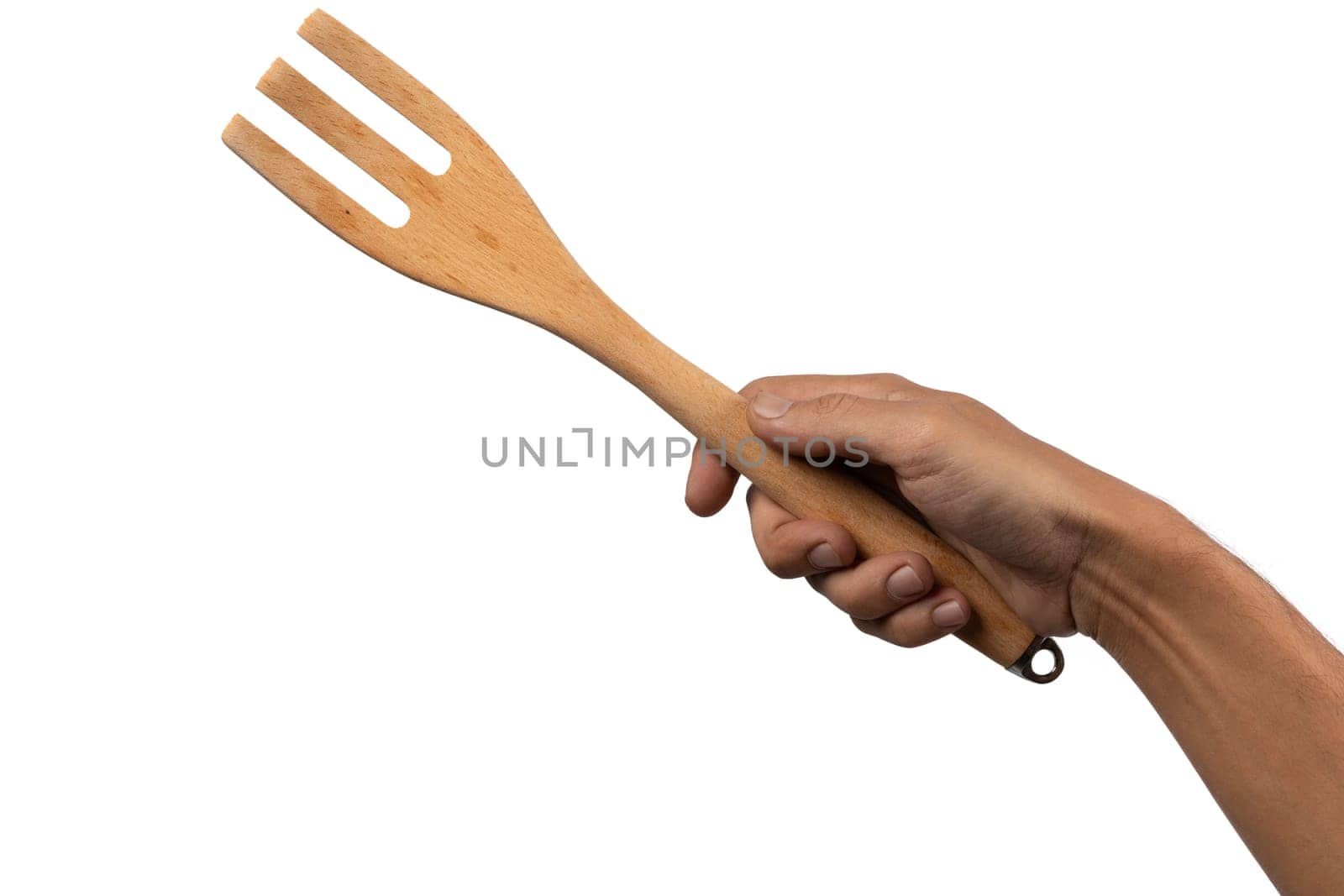 Hand holding wooden fork on white background cutout. High quality photo