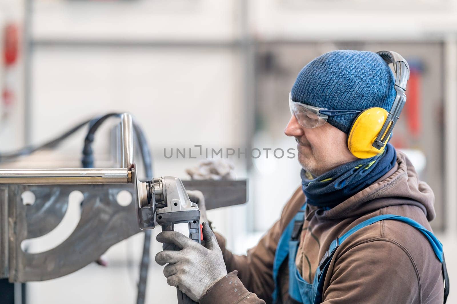 Skilled Worker Operating Machinery in Industrial Environment by Edophoto