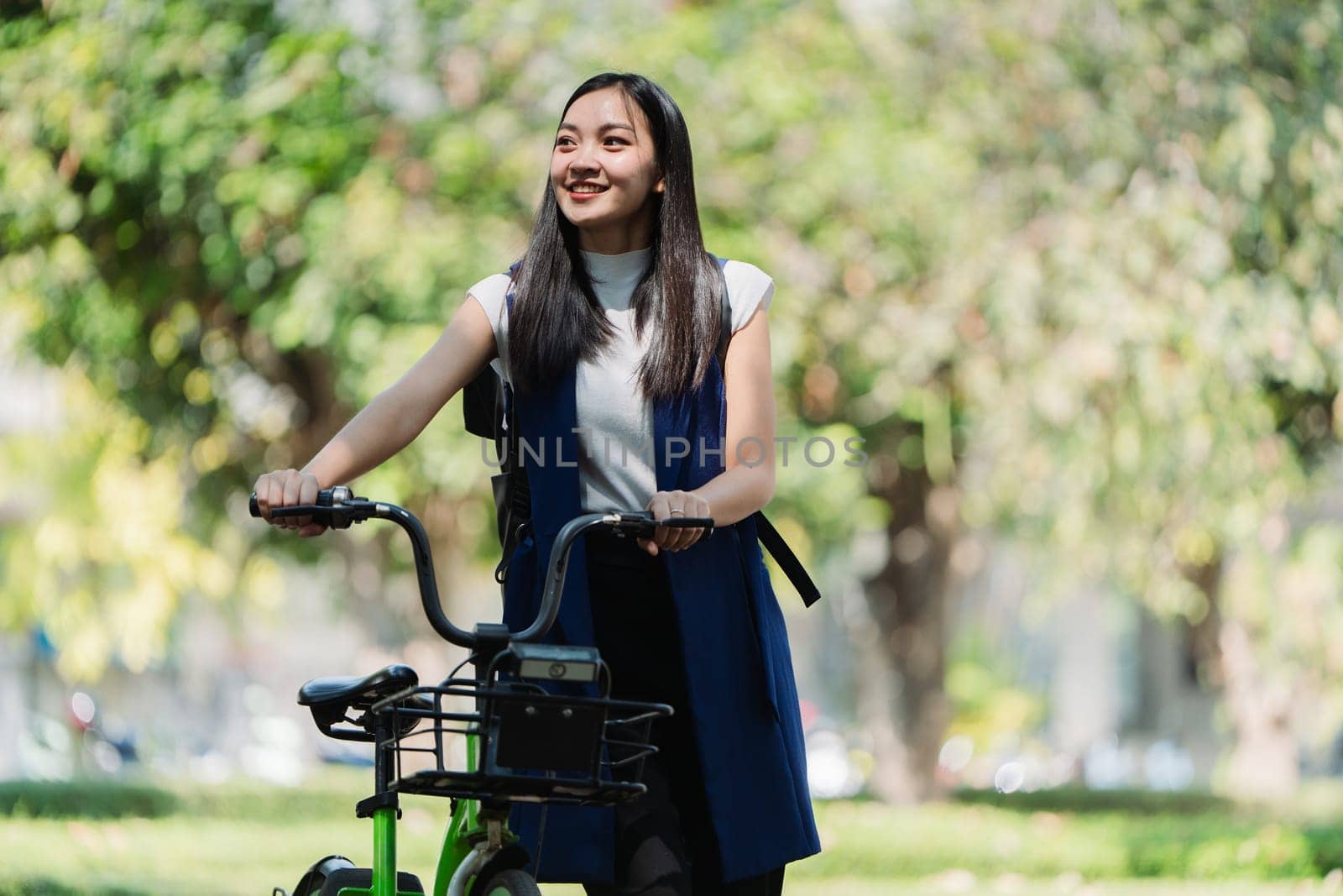 Professional Business woman with bike in the morning walking in the street to work. Eco friendly.