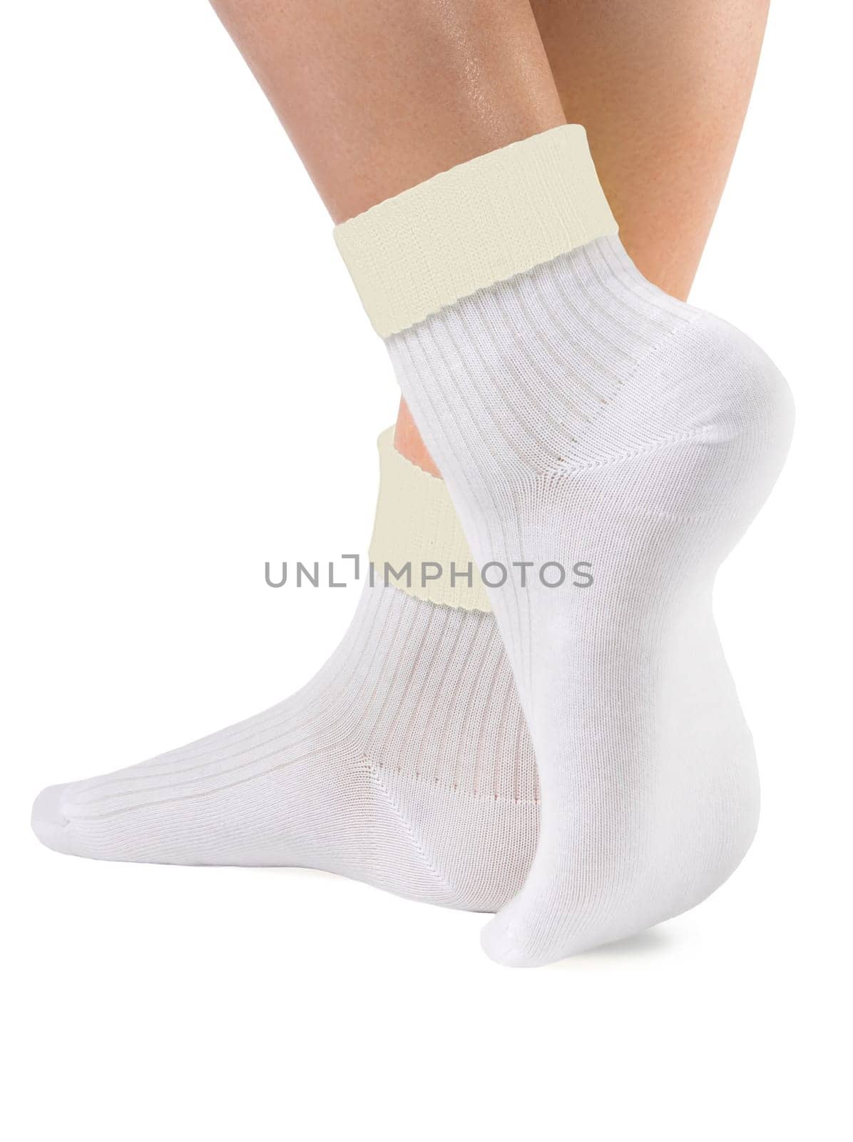 Side view of beautiful woman foot dressed in new nice and soft natural cotton fabric blank white socks with yellow edging isolated on white background. Wearing and sport clothes concept. Detailed closeup studio shot