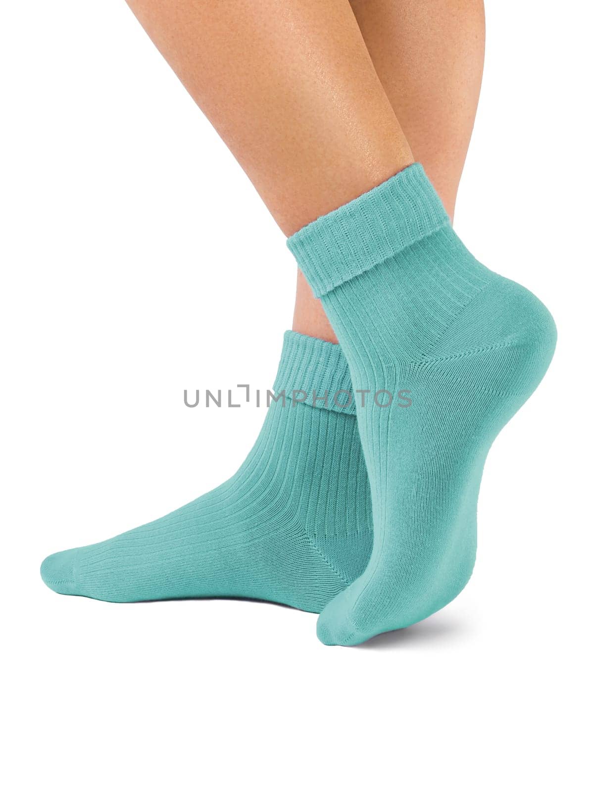 Side view of beautiful woman foot dressed in new nice and soft natural cotton fabric blank green socks isolated on white background. Wearing and sport clothes concept. Detailed closeup studio shot