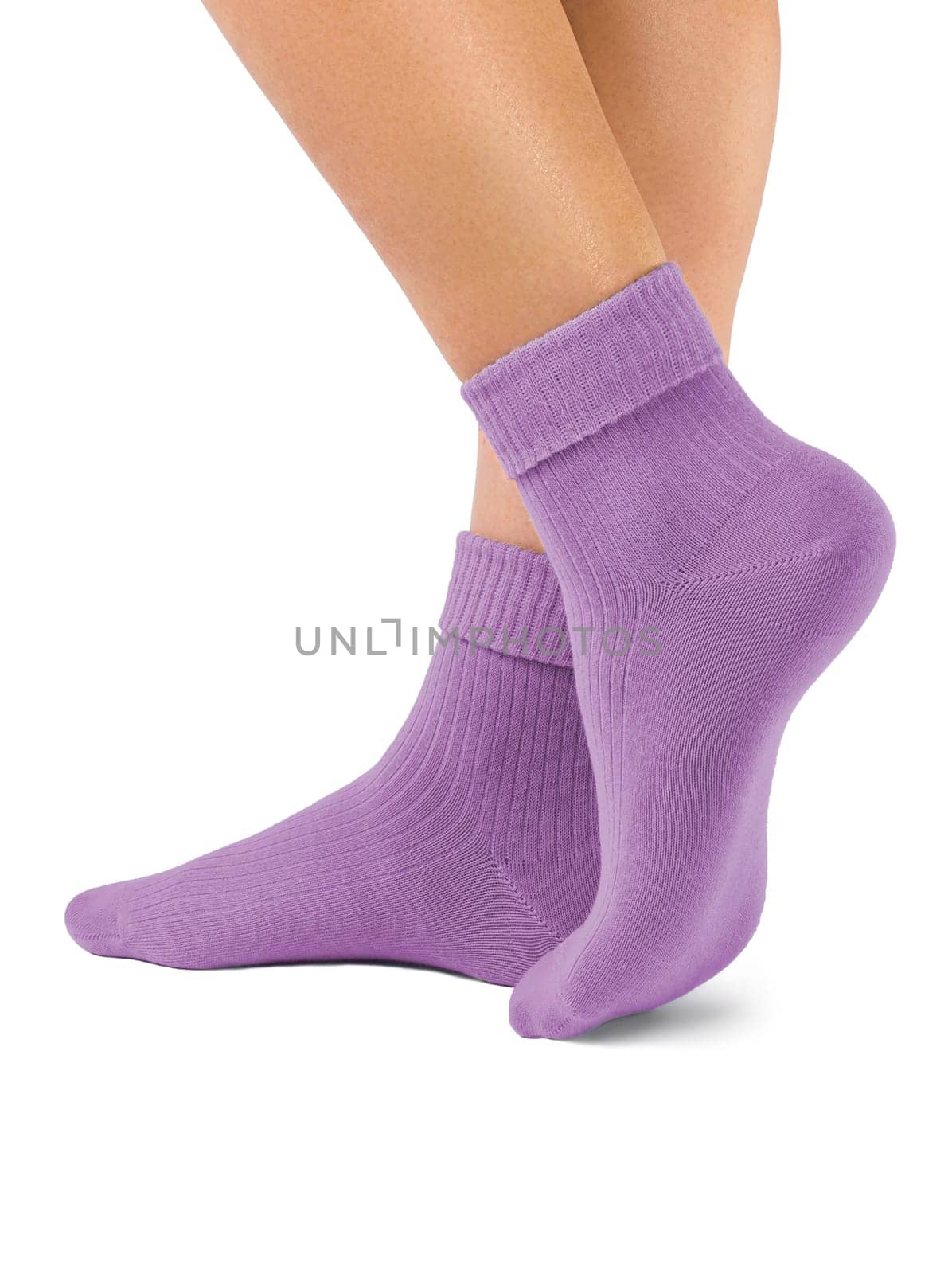Side view of beautiful woman foot dressed in new nice and soft natural cotton fabric blank purple socks isolated on white background. Wearing and sport clothes concept. Detailed closeup studio shot