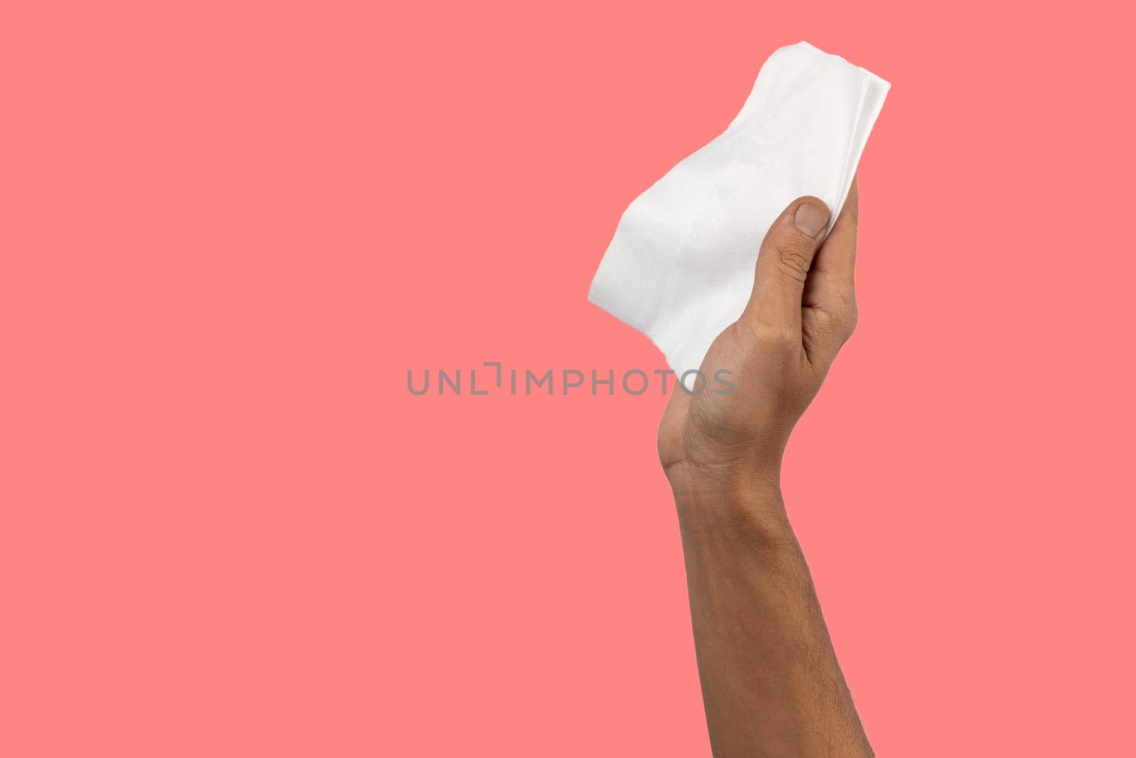 Black male hand holding a cleaning cloth isolated on magenta coral. by TropicalNinjaStudio