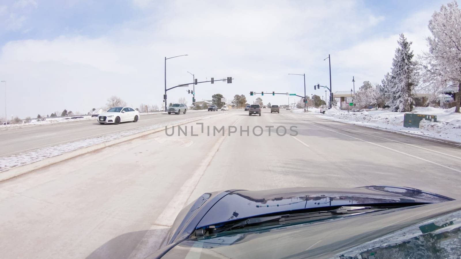 Castle Pines, Colorado, USA-January 30, 2023-Post-winter storm, the drive on a suburban road provides a peaceful journey. The picturesque scene, with snow adorning the landscape, adds to the tranquility of the experience.