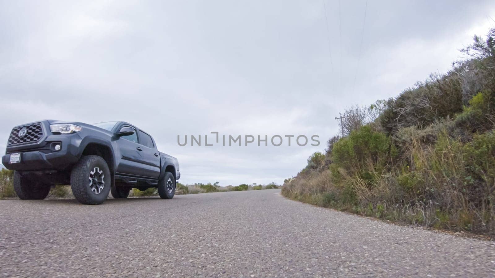 Santa Maria, California, USA-December 6, 2022-In this serene winter scene, a vehicle carefully makes its way along Los Osos Valley Road and Pecho Valley Road within Montana de Oro State Park.