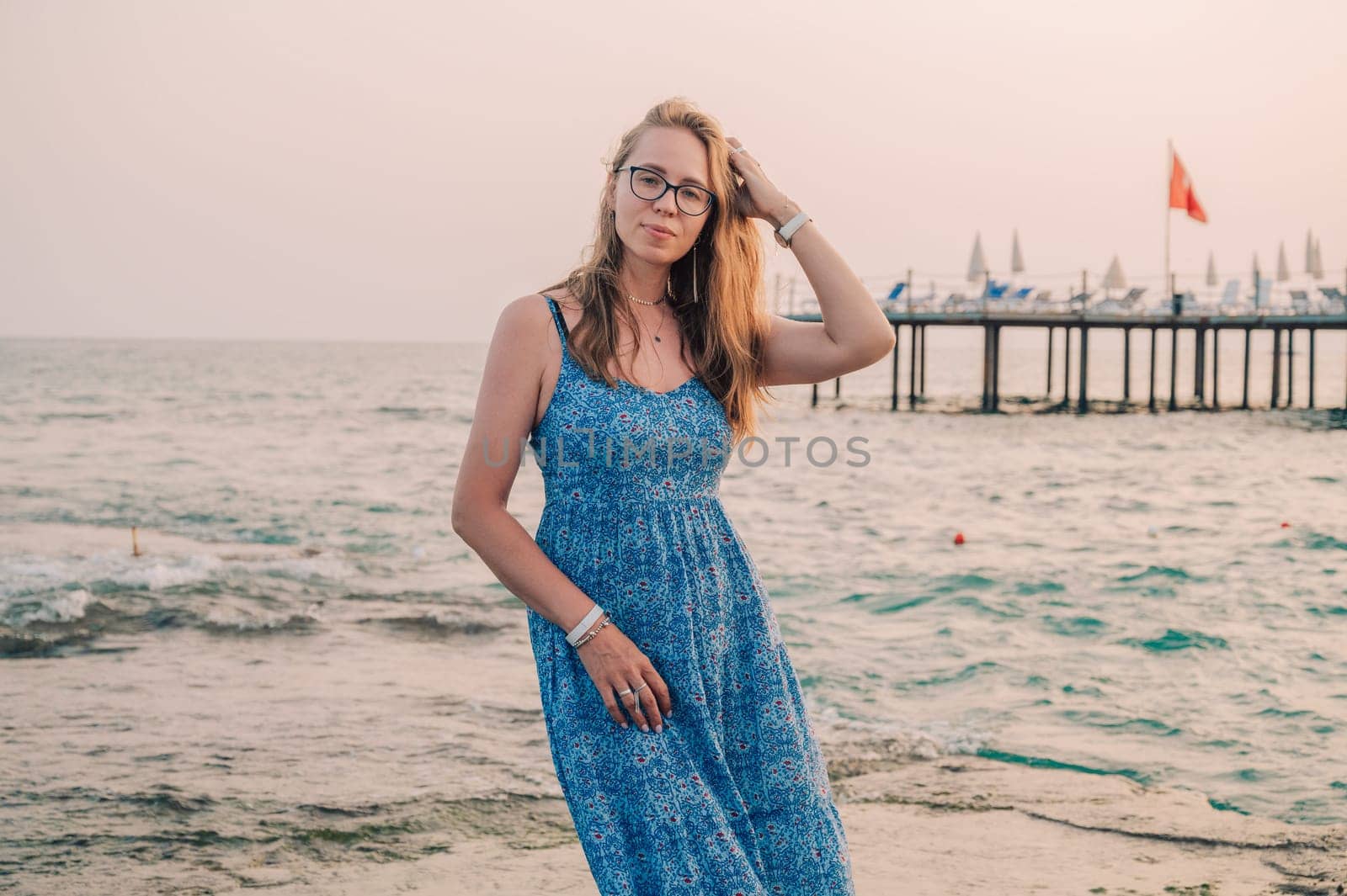 Woman sits on the beach and looks at the sea in Alanya city, Turkey. Travelling or vacation concept