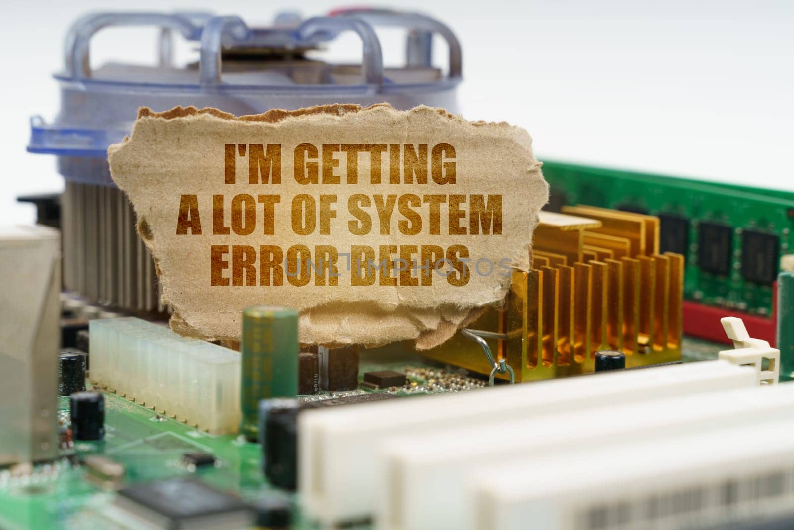 On the computer motherboard there is a cardboard with the inscription - I'm getting a lot of system error beeps. Computer repair concept.