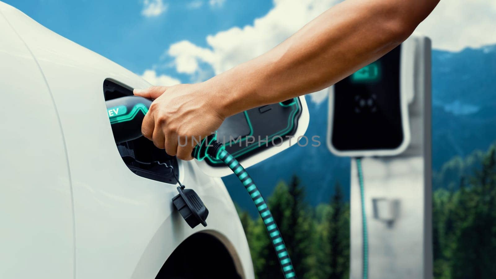 Hand insert EV charger and recharge electric car on nature and travel. Peruse by biancoblue
