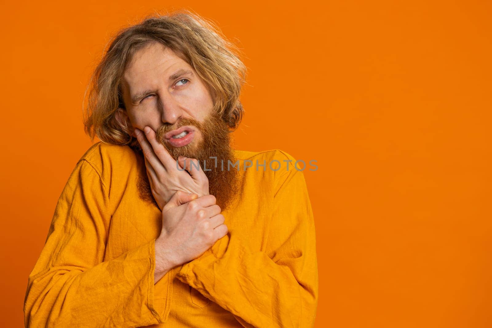 Caucasian man touching cheek closing eyes with expression of terrible suffer from painful toothache by efuror