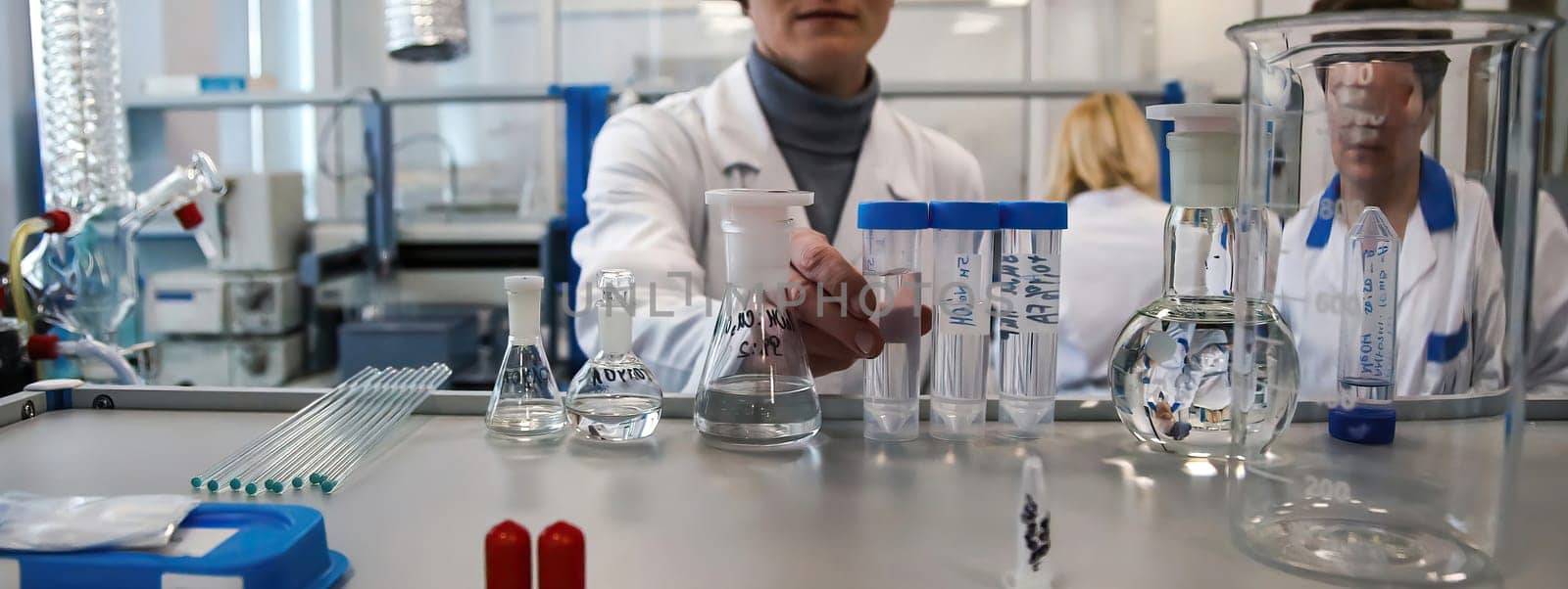 The doctor takes a test tube with liquid, close-up. Work in a chemical laboratory. Laboratory analysis