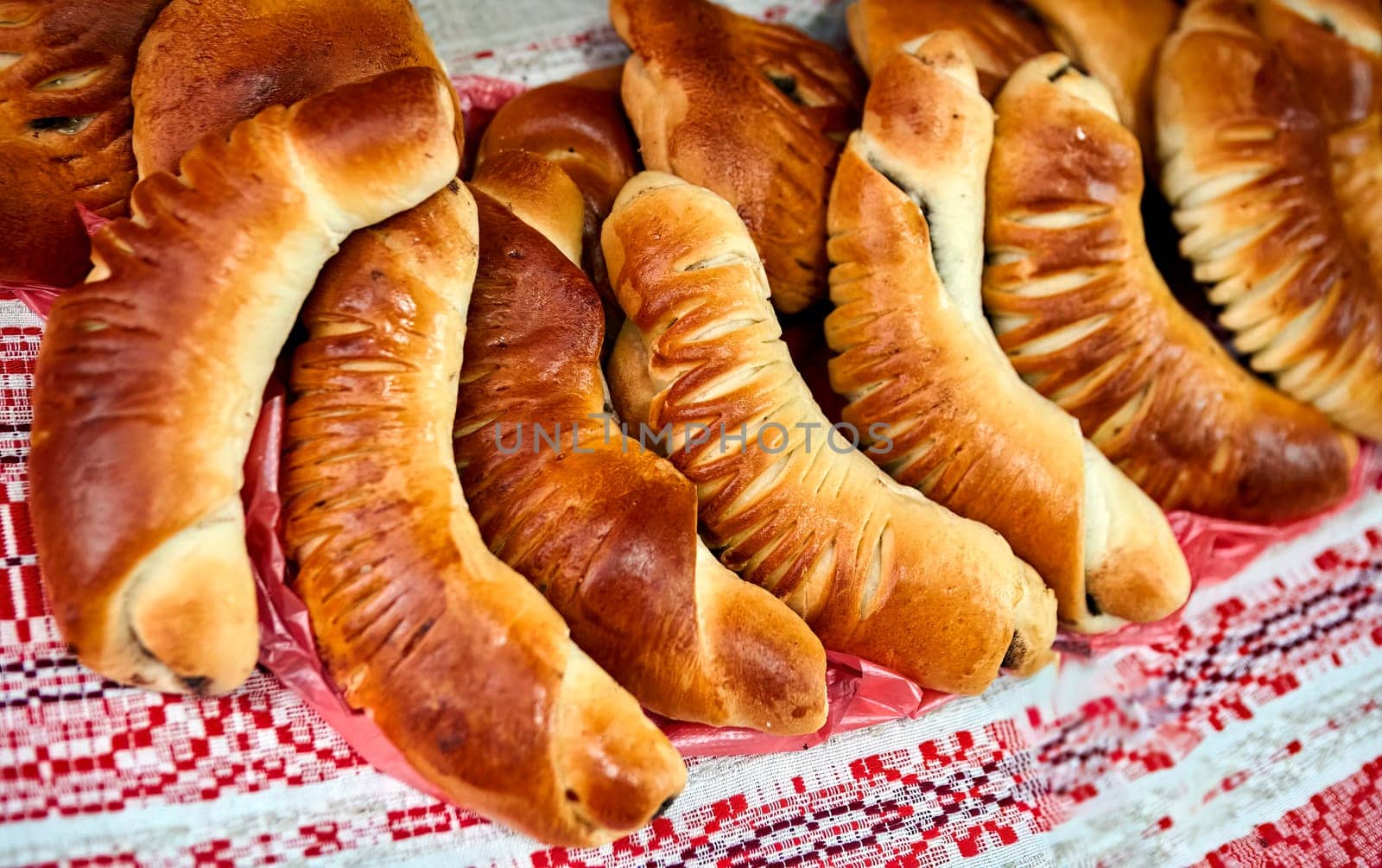 Assorted freshly baked bread and rolls on a white table. Golden brown, crusty bread and soft, fluffy rolls in various shapes and sizes. Perfect for breakfast, lunch, or dinner.