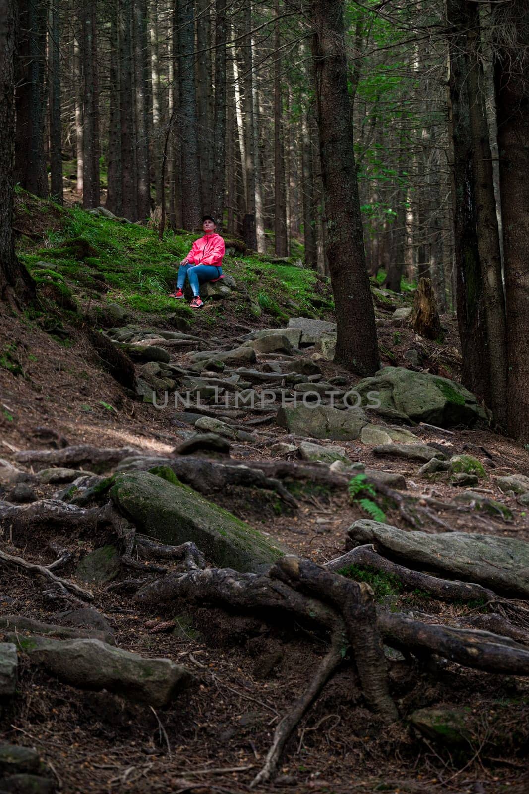 a woman sits on a fireplace near a path in the mountains. by Niko_Cingaryuk