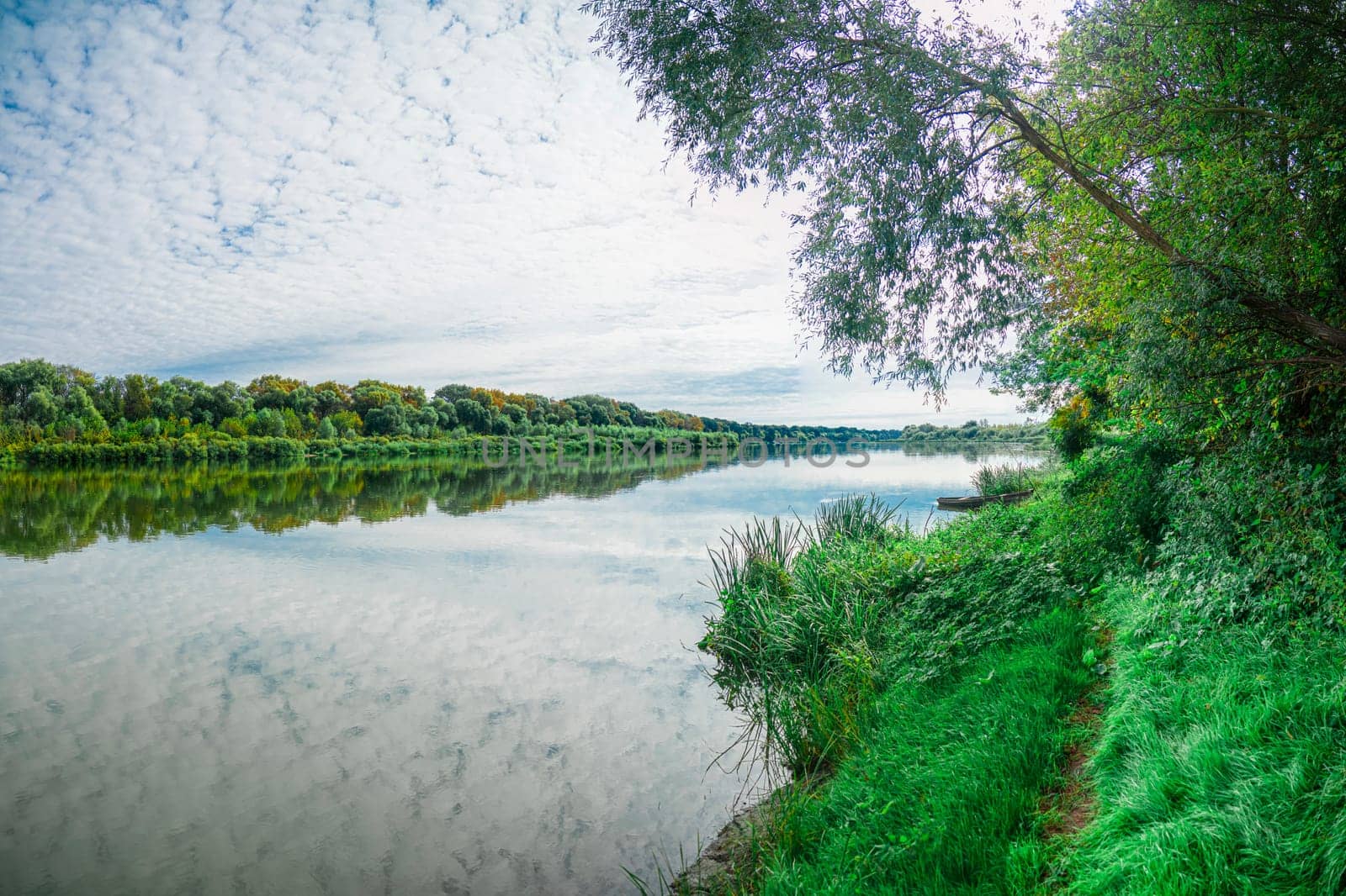 Wooden boat on the river bank. 4K