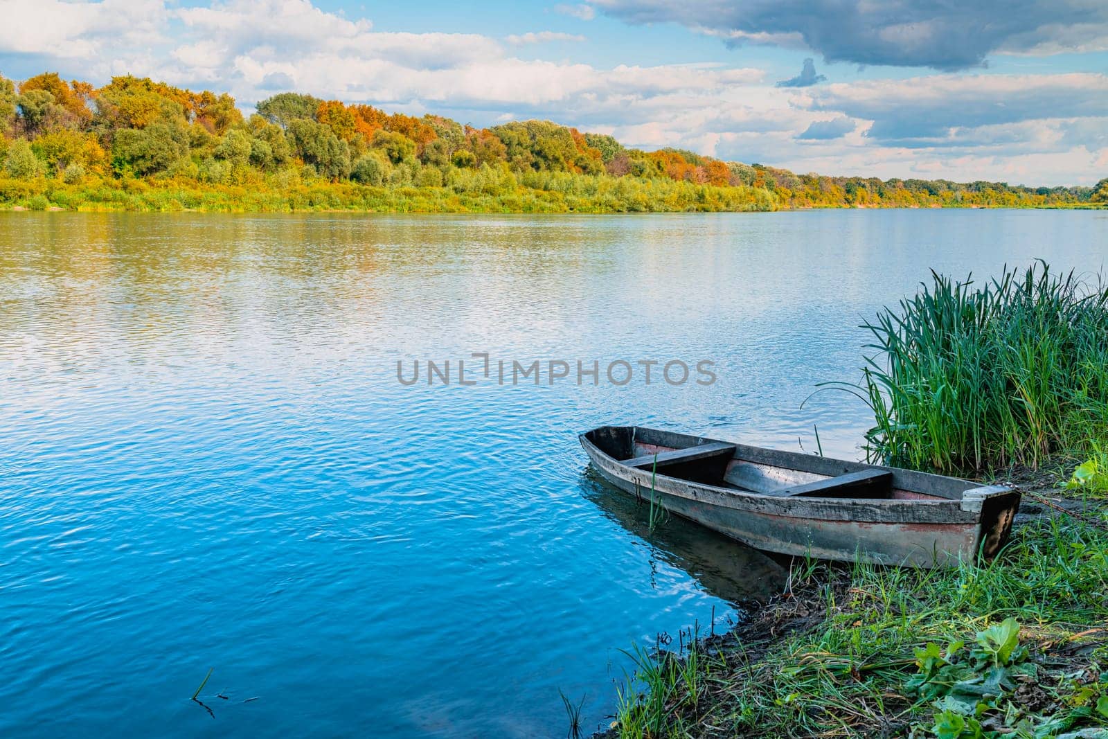 Wooden boat on the river bank. 4K