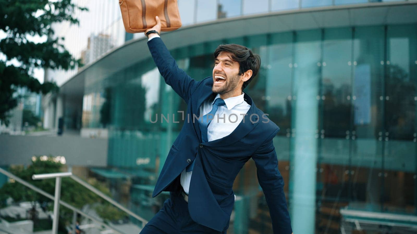 Successful business man celebrate for getting promotion while walking to office. Caucasian receive good news about sales increase or successful project. Manager feel overjoy and happy. Exultant.