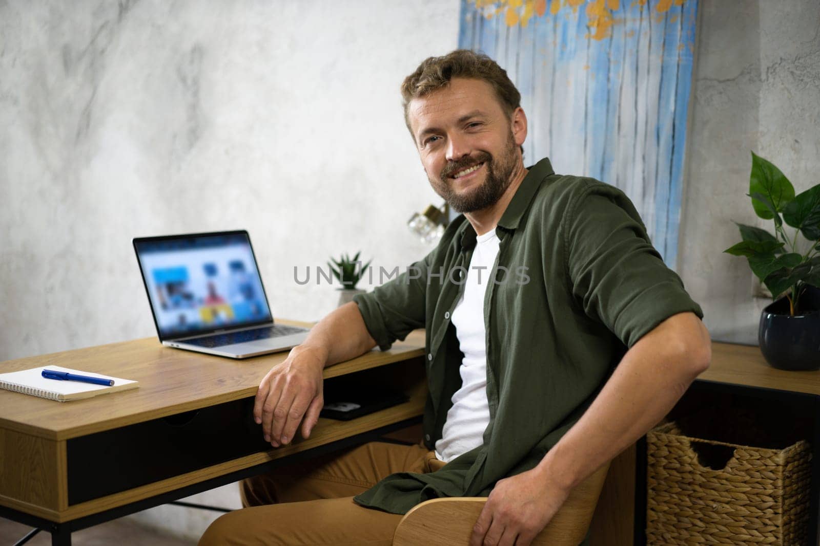 Man Working on Laptop at Desk by LipikStockMedia