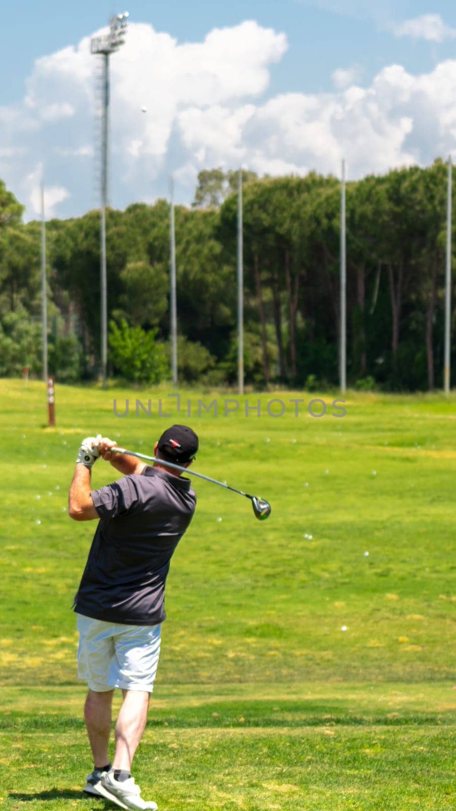 Belek, Turkey - May 13, 2022: Man playing golf in Sueno hotel golf Belek on driving range at the
