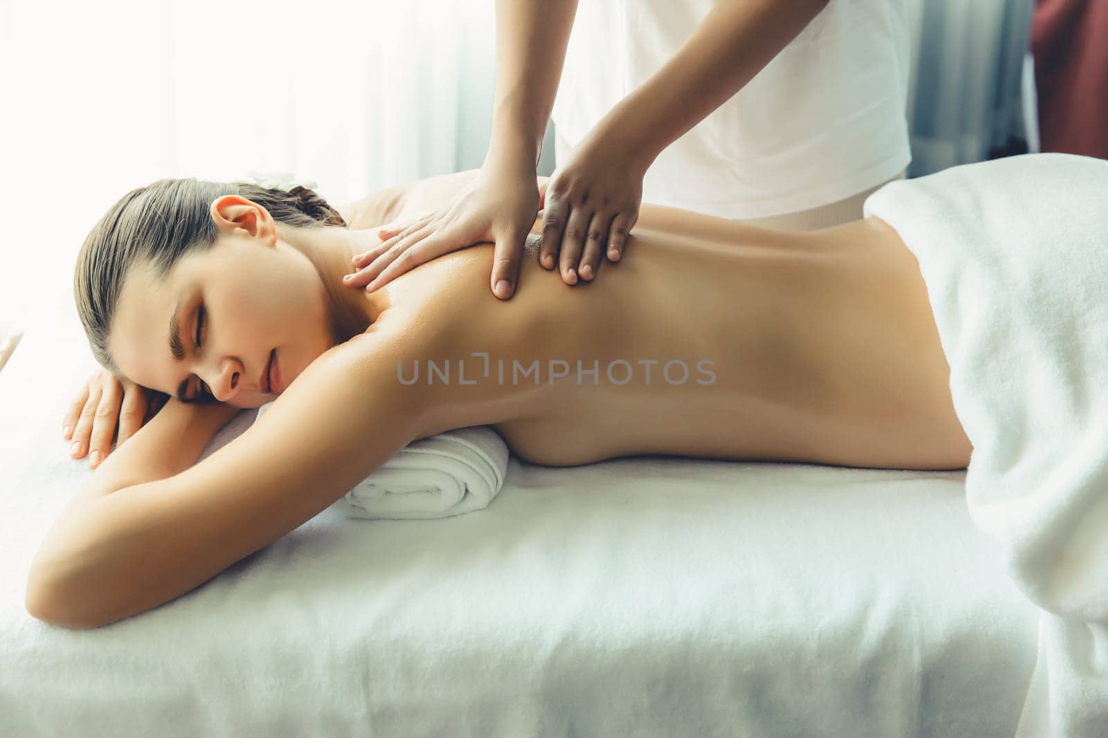 Caucasian woman customer enjoying relaxing anti-stress massage. Quiescent by biancoblue